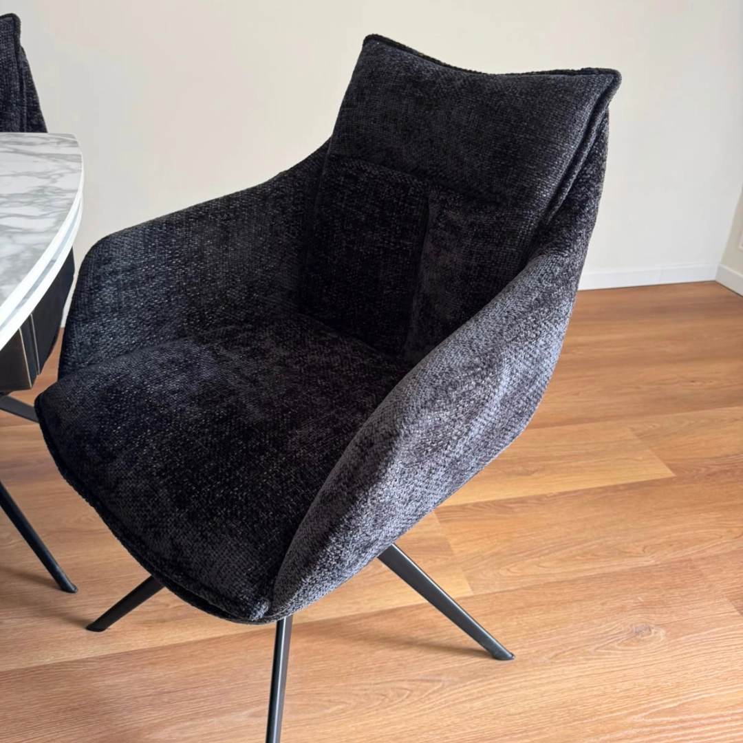 Vista laterale sedia moderna imbottita con braccioli e base a croce - Marca Design Shop