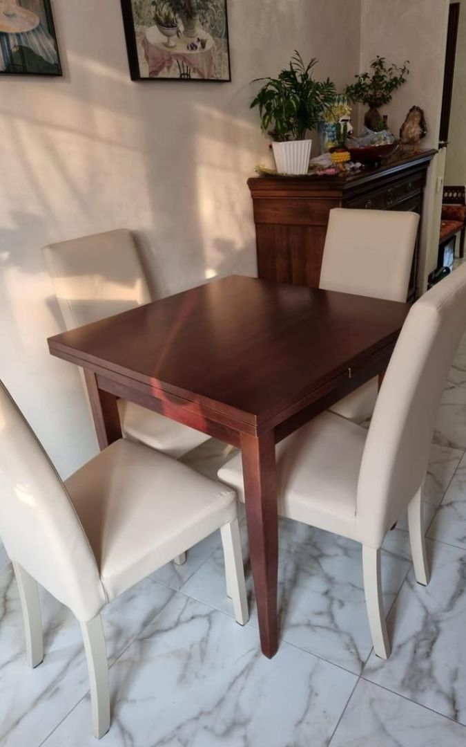 Dettaglio piano del tavolo allungabile in legno, venature del noce.