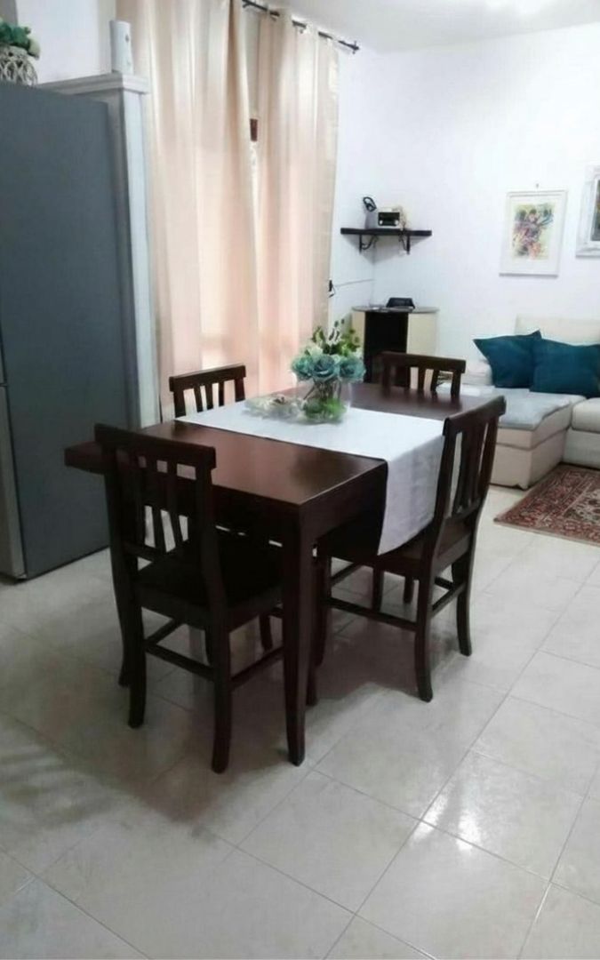 Tavolo rettangolare allungabile in legno noce, vista dettagliata della finitura.