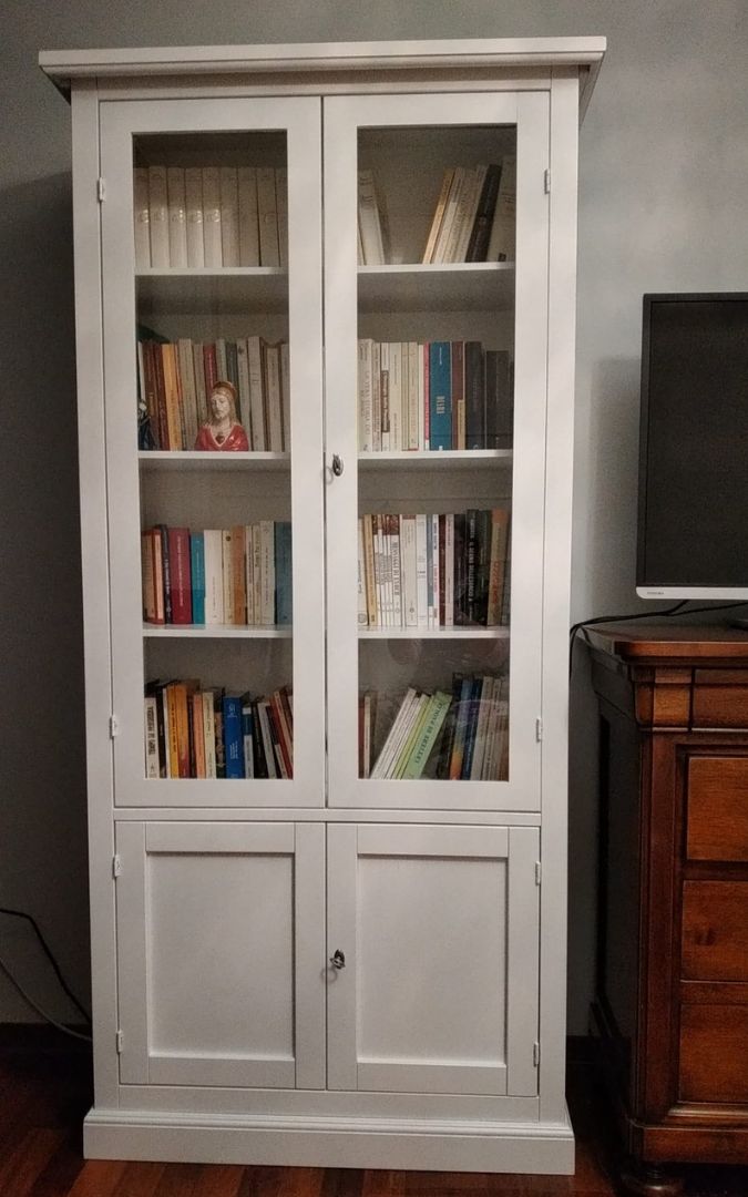 Vetrina bianca in legno in un angolo della stanza, design minimalista e senza tempo.