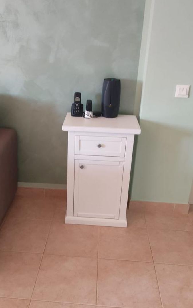 Mobiletto porta telefono in legno massello con finitura bianco opaco, ideale come piccolo complemento d'arredo per ingresso o salotto.